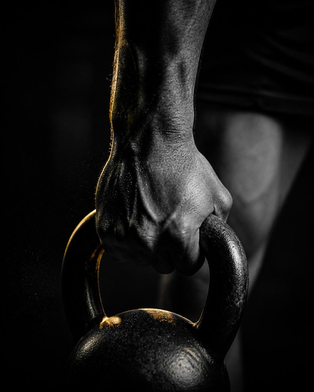 Symbol of resilience and discipline — a hand gripping a kettlebell